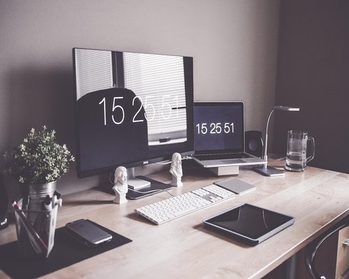 Modern computer setup with ergonomic chair and desk lamp